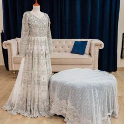 A complete net bridal ensemble for Walima celebration. Maxi and dupatta adorned with hand embroidery, pearls, Swarovski crystals, gems, and 3D sequins, exuding elegance and opulence.