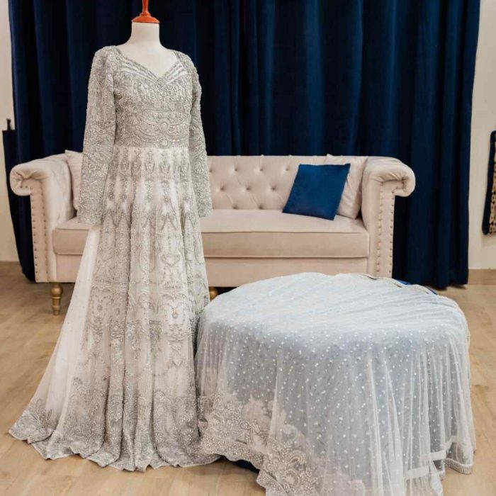 A complete net bridal ensemble for Walima celebration. Maxi and dupatta adorned with hand embroidery, pearls, Swarovski crystals, gems, and 3D sequins, exuding elegance and opulence.